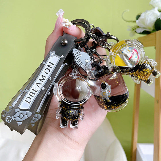 Flytande astronaut nyckelring