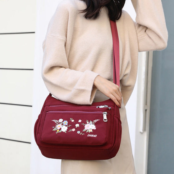 Moderiktig axelväska med broderat blommönster för damer